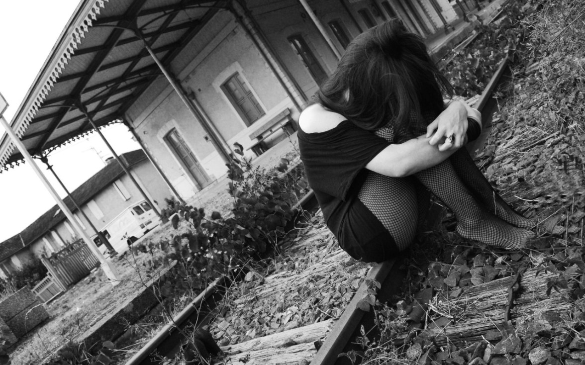 Sad girl on railway track