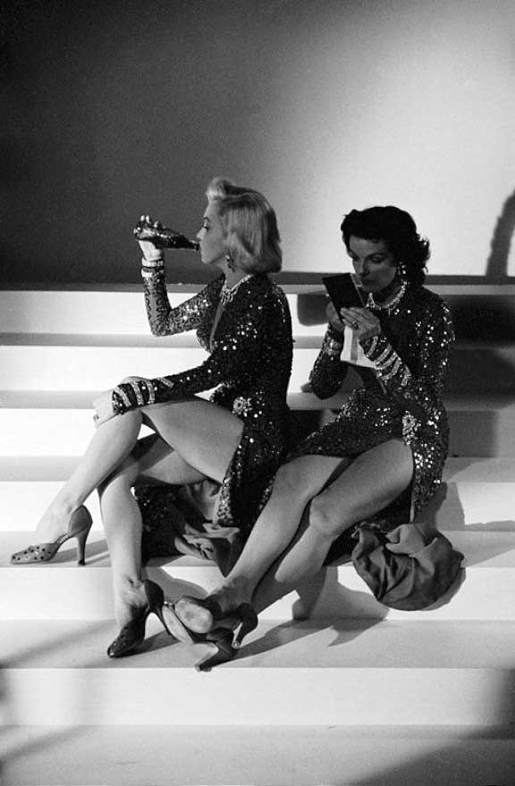Marilyn Monroe and Jane Russell taking a break on the set of Gentlemen Prefer Blondes.